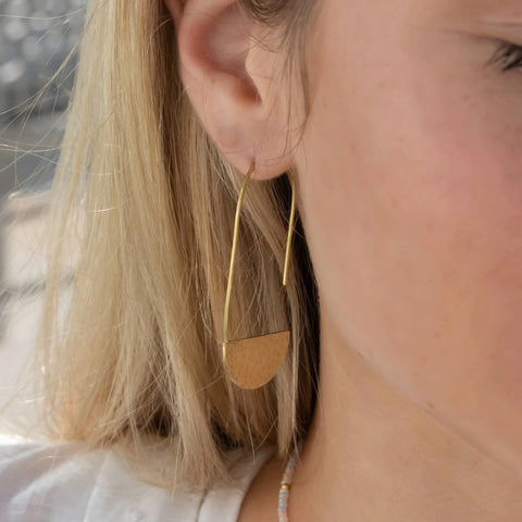 Fair trade hammered brass moon earrings handmade by survivors of human trafficking.