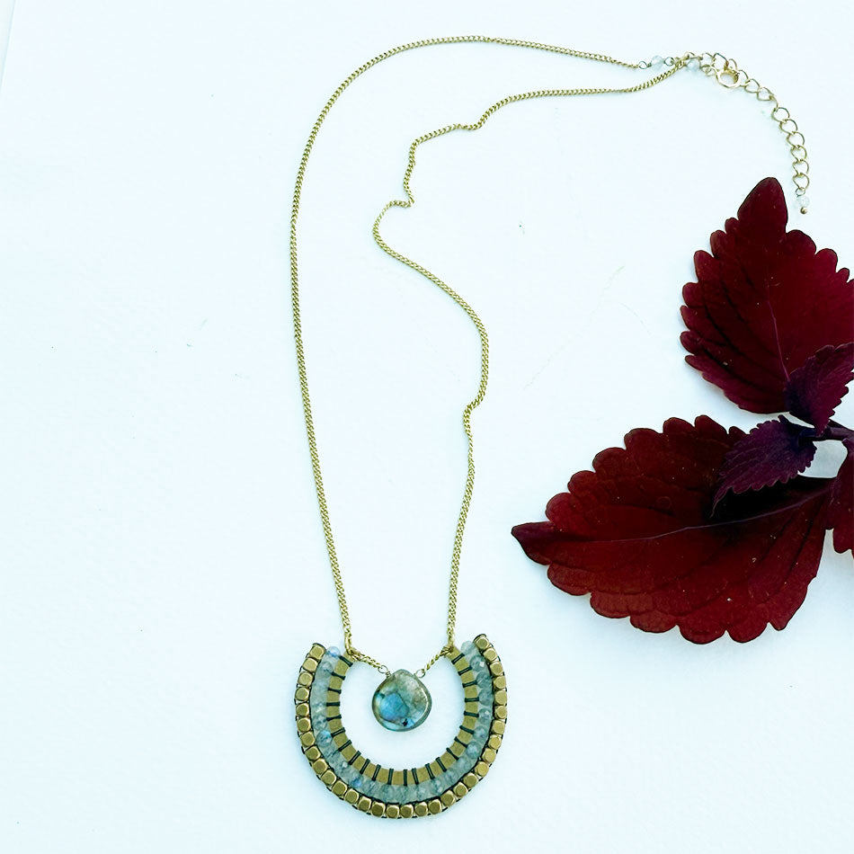 This fair trade necklace features labradorite and brass and is a statement piece.