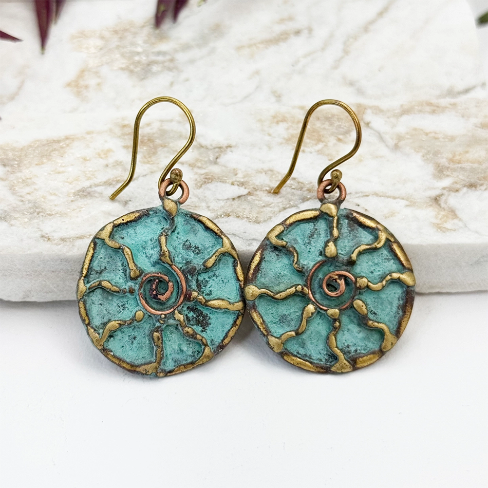 Round dangle earrings with brass sun and green patina finish.