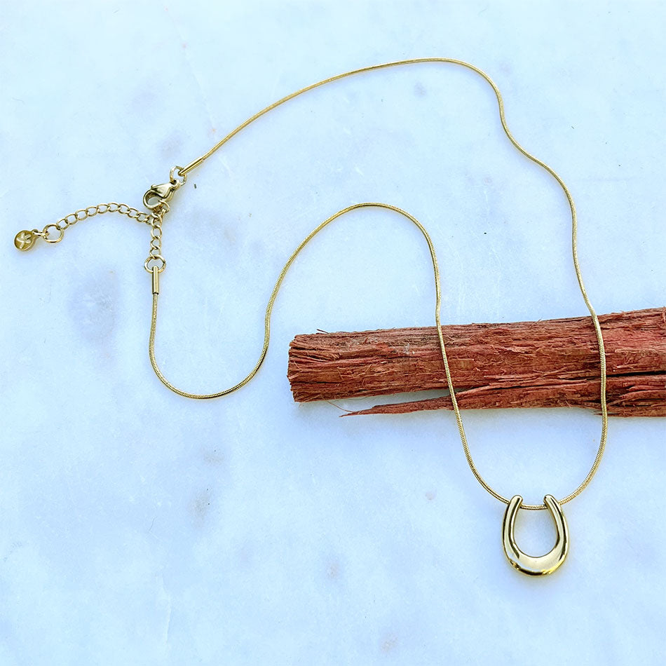 Fair trade horseshoe necklace handmade by survivors of human trafficking