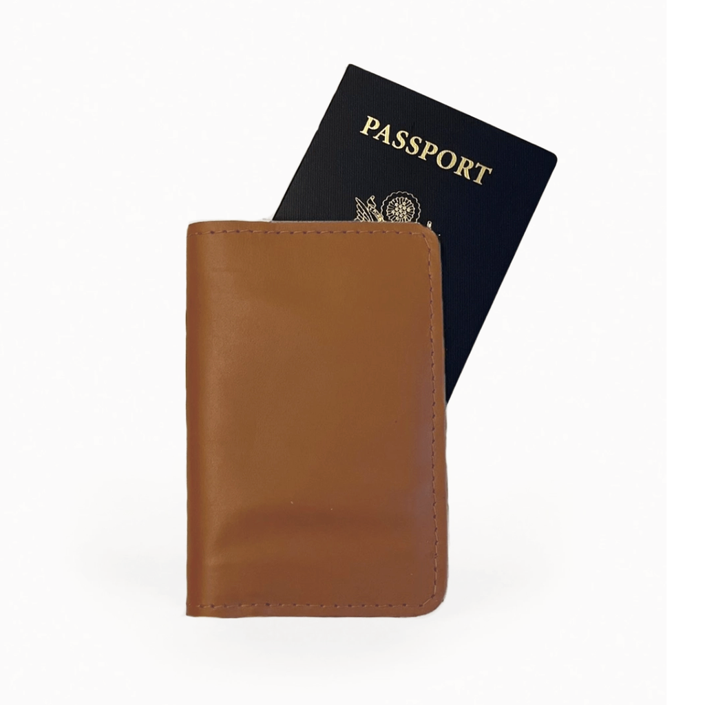 Tan leather passport holder with passport shown inside