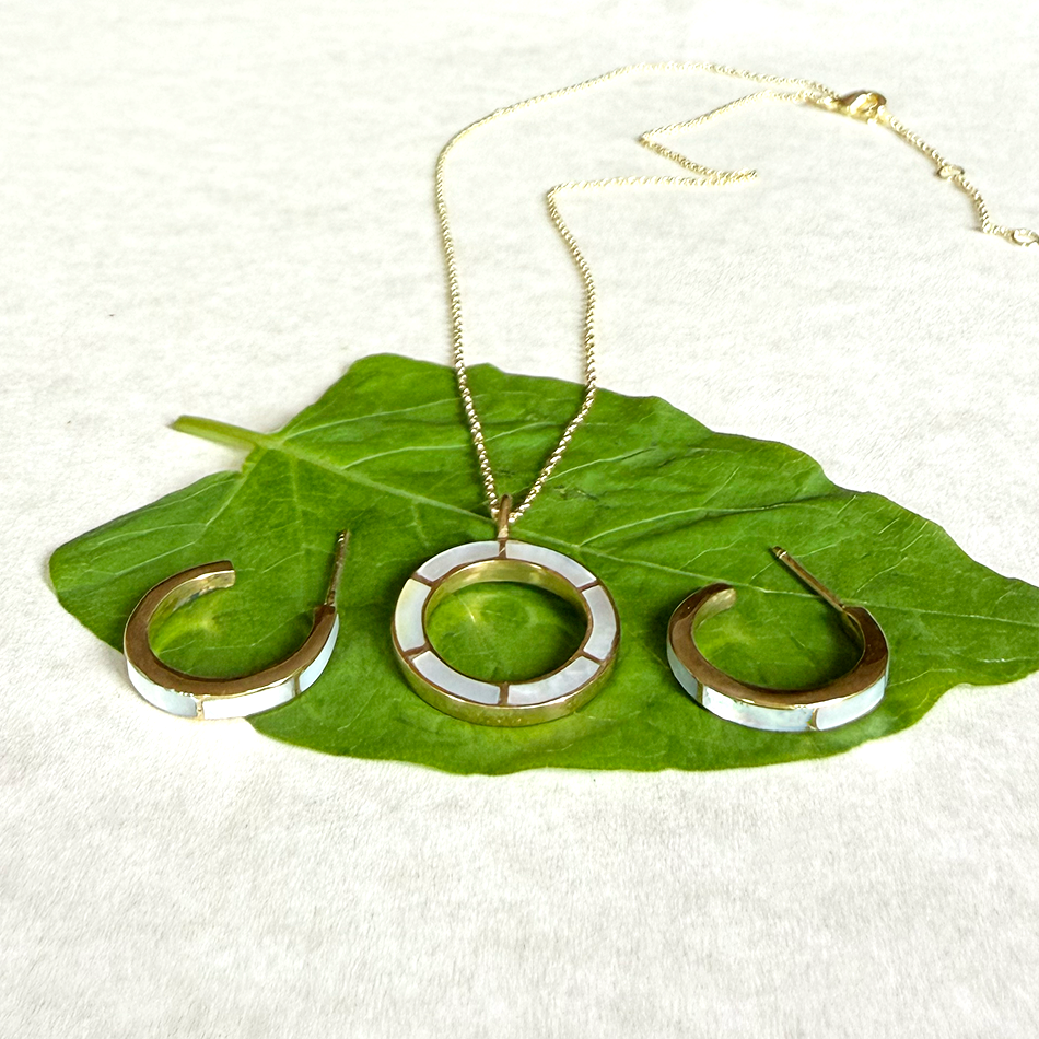 Necklace circle of brass with inlaid mother-of-pearl on gold chain and pearl huggies to match.