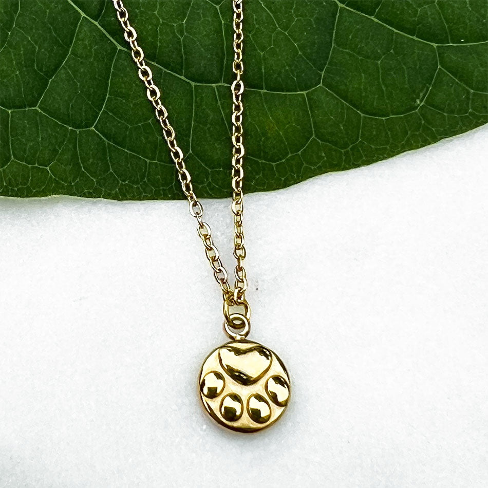 Fair Trade gold paw print necklace handmade by survivors of human trafficking