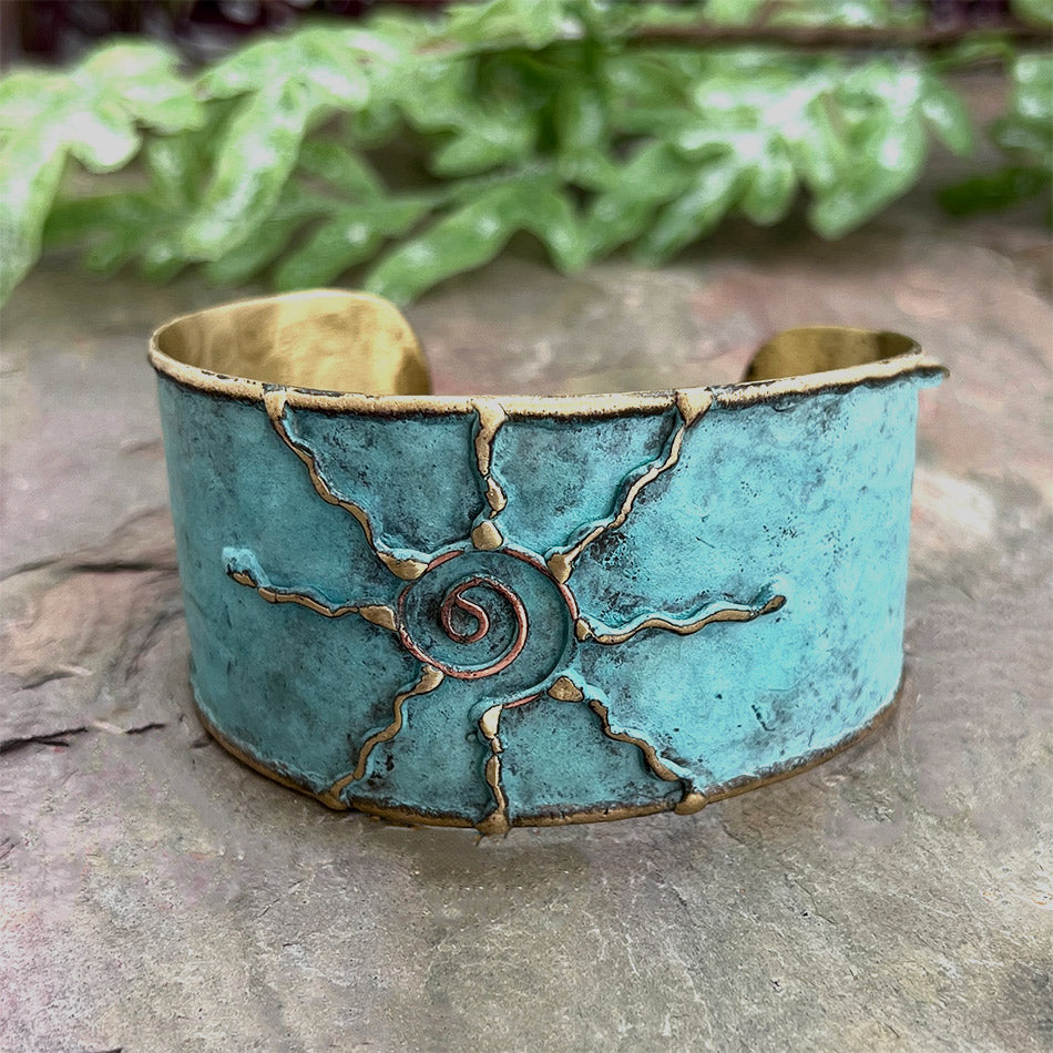 Fair trade brass sun cuff with patina finish handmade by artisans in India.