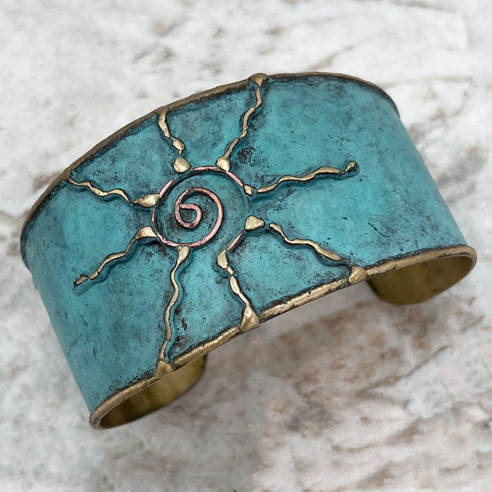 Fair trade brass sun cuff with patina finish handmade by artisans in India.