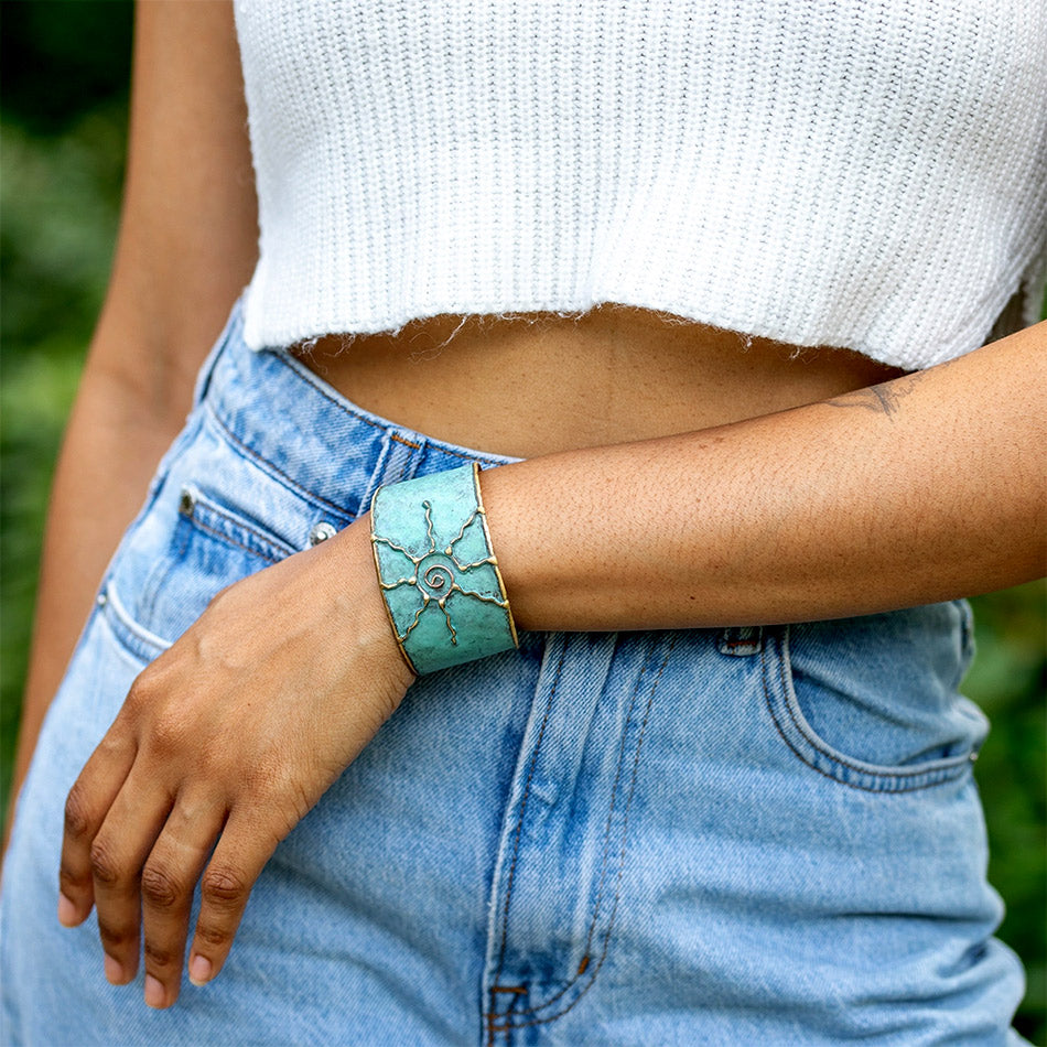 Fair trade brass sun cuff with patina finish handmade by artisans in India.
