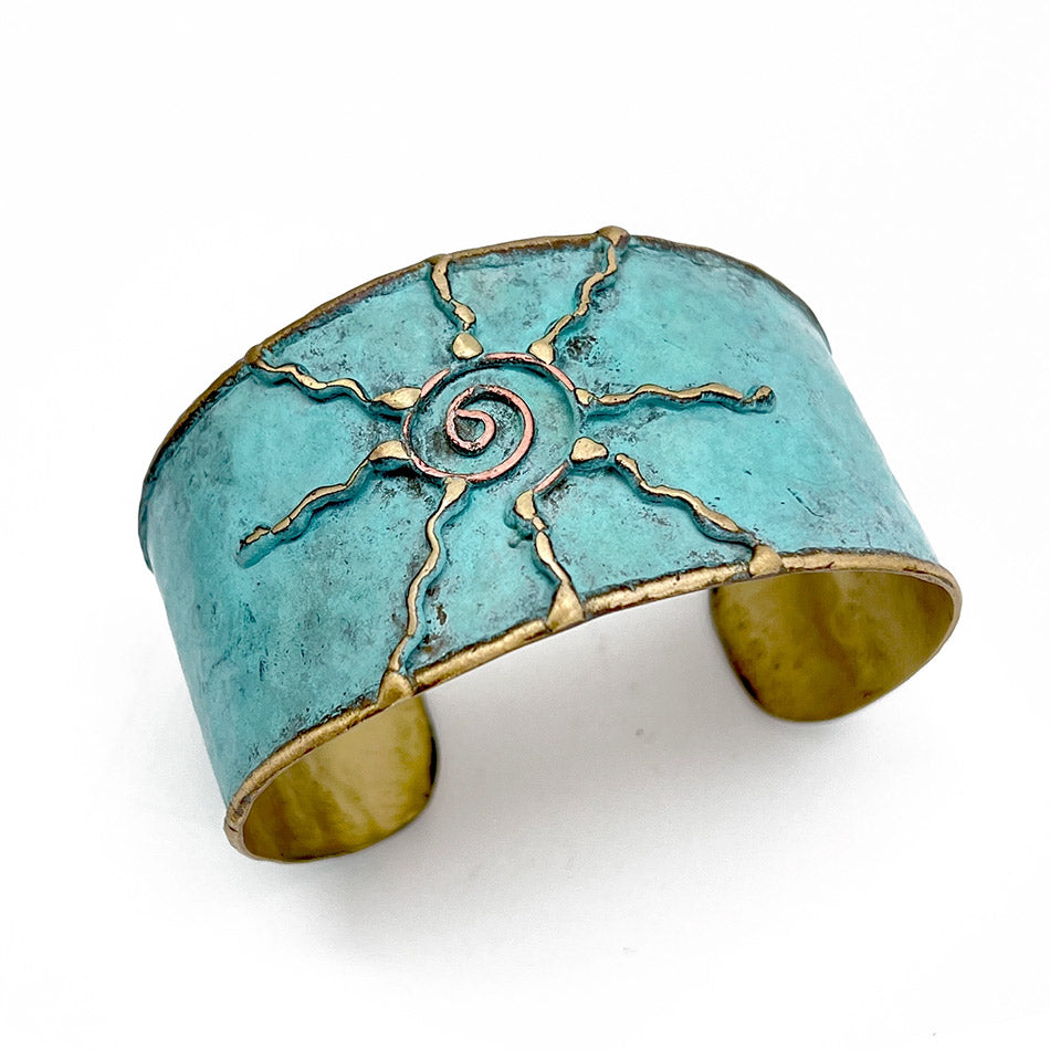 Fair trade brass sun cuff with patina finish handmade by artisans in India.