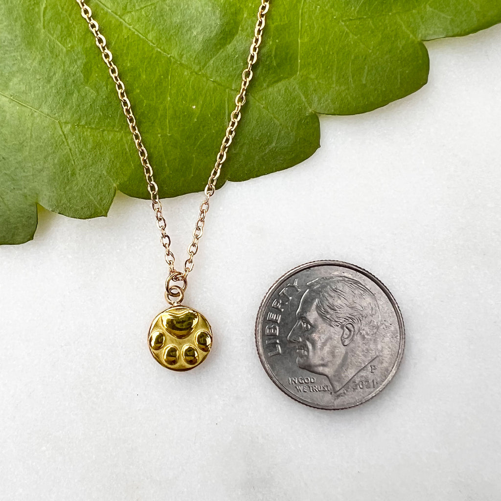 Fair Trade gold paw print necklace handmade by survivors of human trafficking