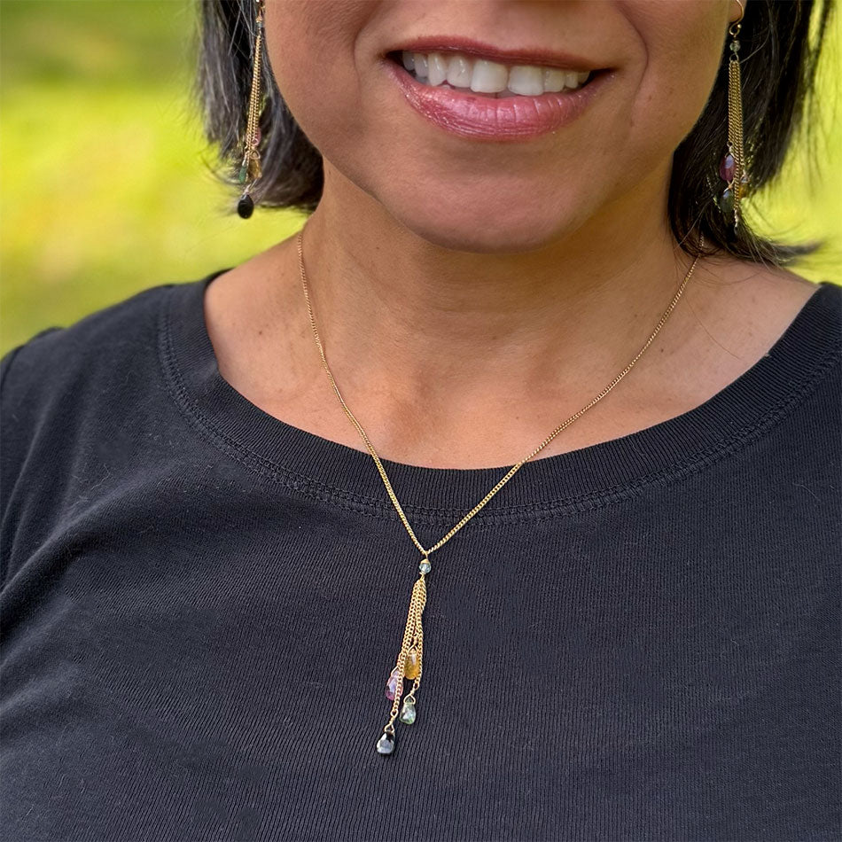 This necklace features  colortul tourmaline stones and a brass chain.