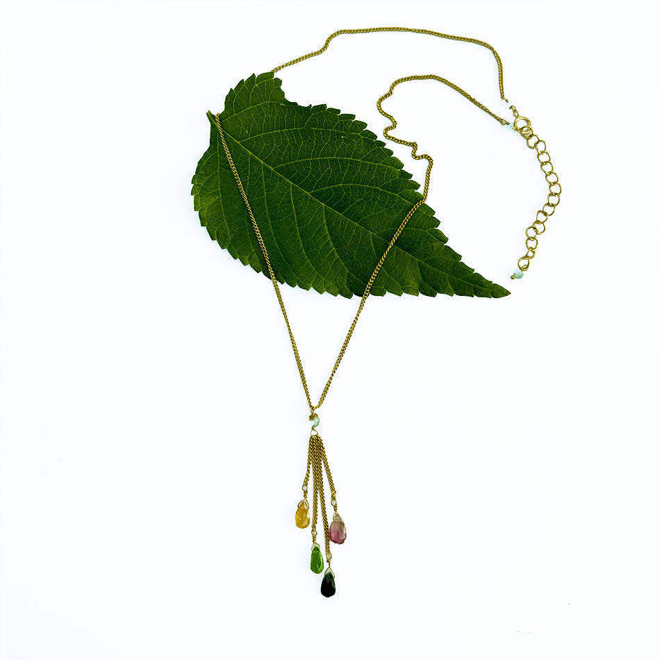 This necklace features  colortul tourmaline stones and a brass chain.