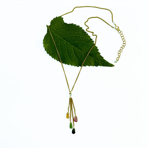 This fair trade necklace features different colored tourmaline stones and a brass chain.