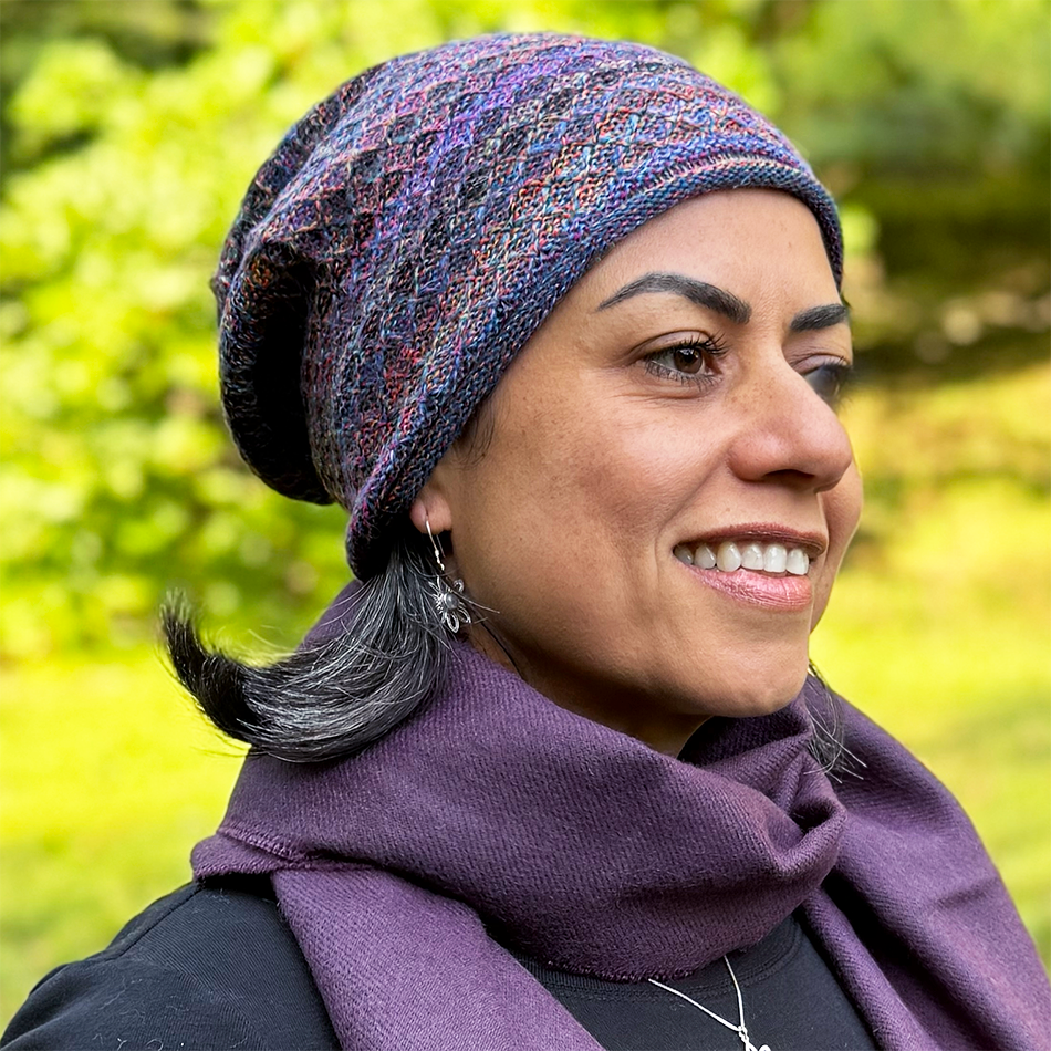 Fair trade baby alpaca knitted hat with purple, pink, blue and more colors.