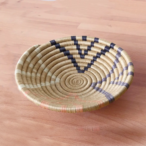 Fair trade sweetgrass basket handmade in Rwanda, natural color with colored accents.