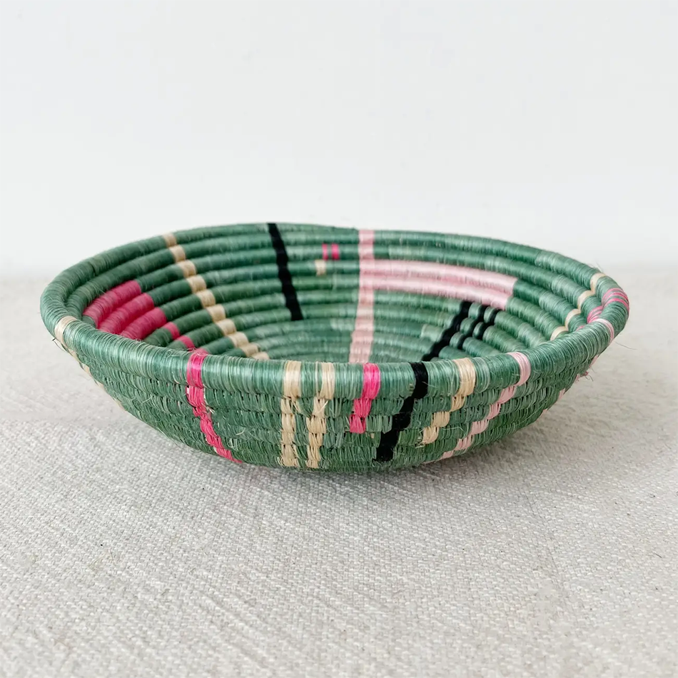 Fair trade sisal bowl basket with sweetgrass, green with pink and black modern design handmade in Rwanda.
