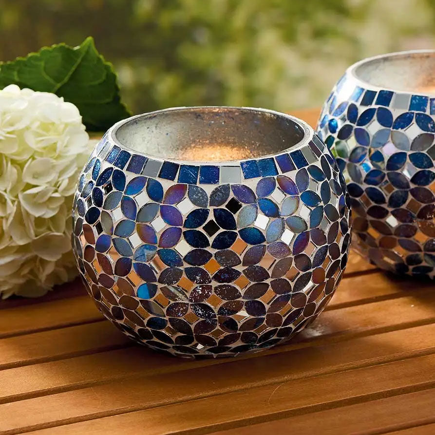 Fair trade candle holder with colorful mosaic glass pattern.