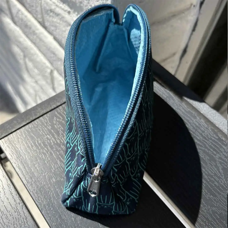 Inside of Fair trade recycled cotton cosmetic bag with screen printed cat design in blue.