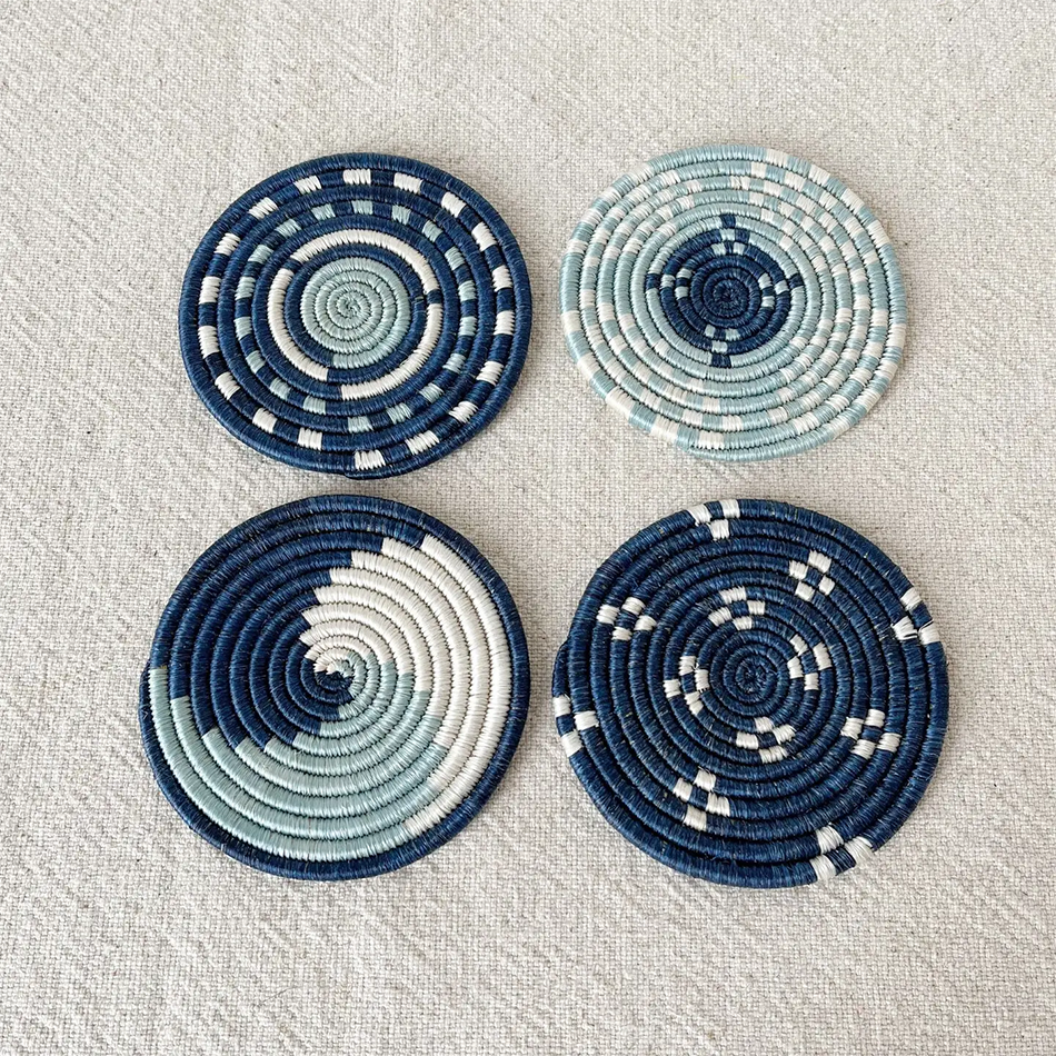 Fair trade handwoven coasters made in Rwanda out of sweetgrass.  Set of four in blue and white designs.