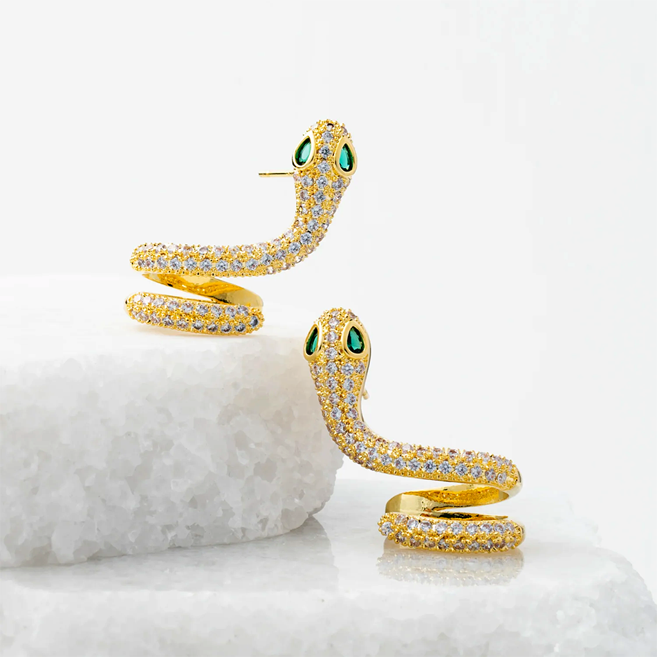 Snake earrings with gold and zircon stones, handmade by survivors of human trafficking.