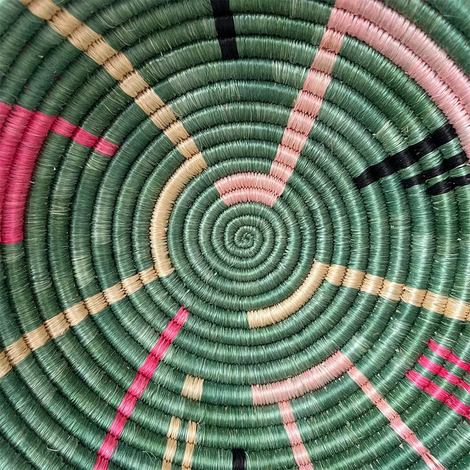 Fair trade sisal bowl basket with sweetgrass, green with pink and black modern design handmade in Rwanda.