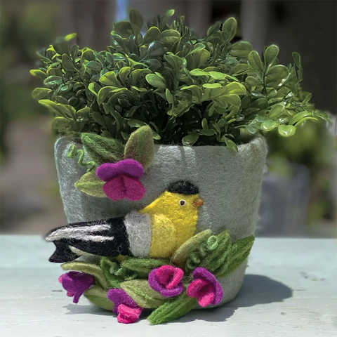 Felted wool flower pot with goldfinch and sweetpea design on the outside.