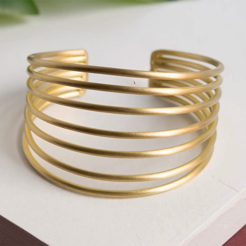 Gold-plated statement cuff bracelet with 7 metal bars.