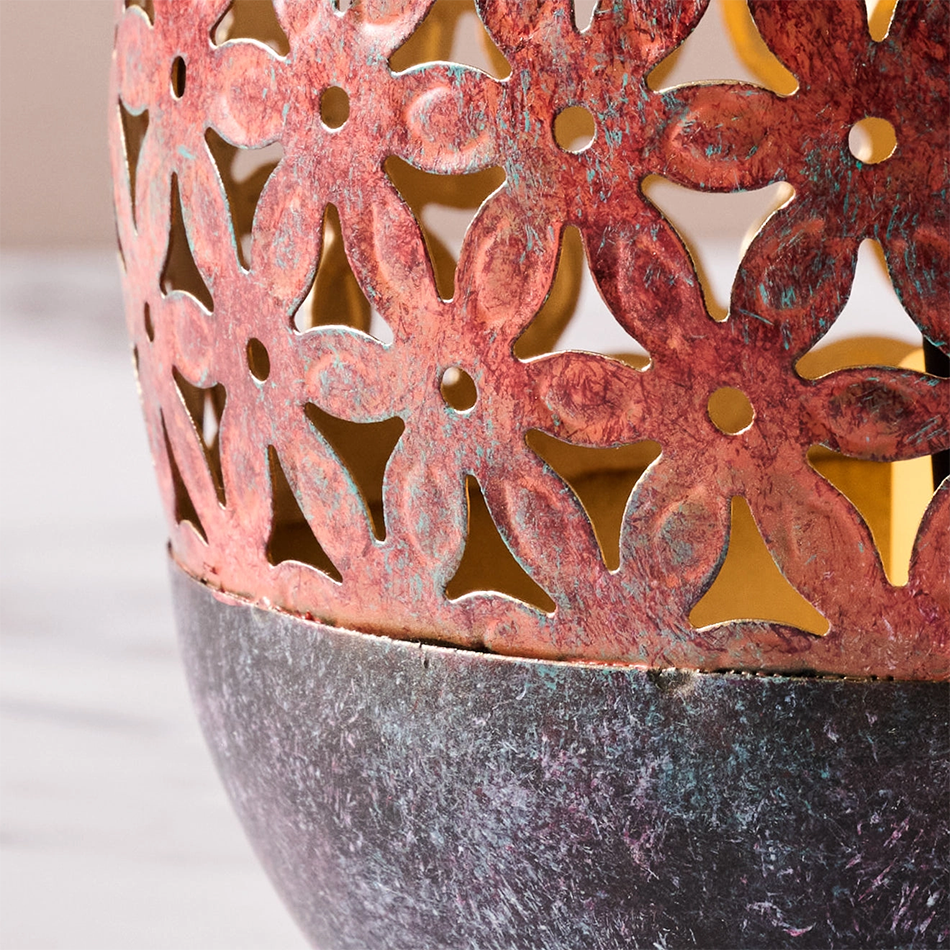 Painted iron lantern for tea lights with floral pattern.