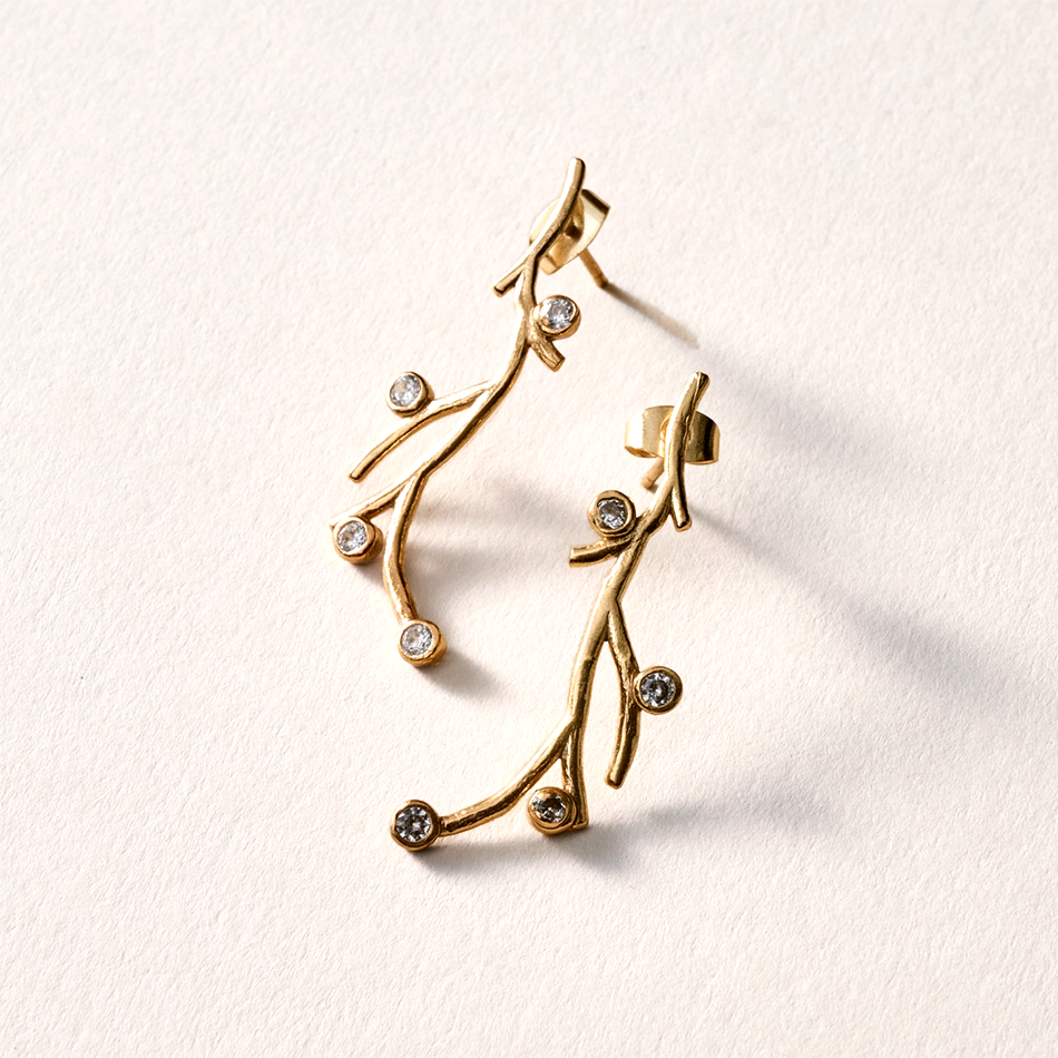 Brass post-style earrings with branches and cubic zirconia stone.