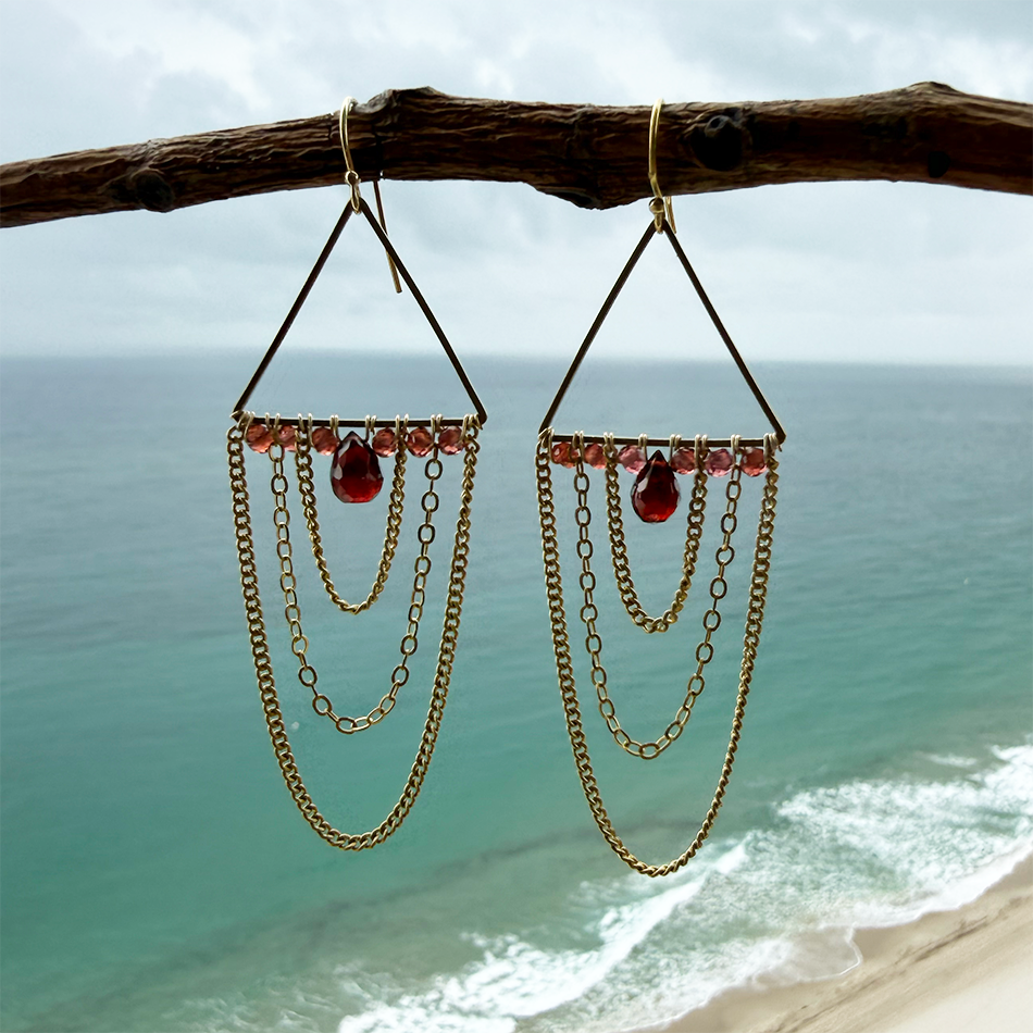 Brass earrings with multiple chains and garnet stone.