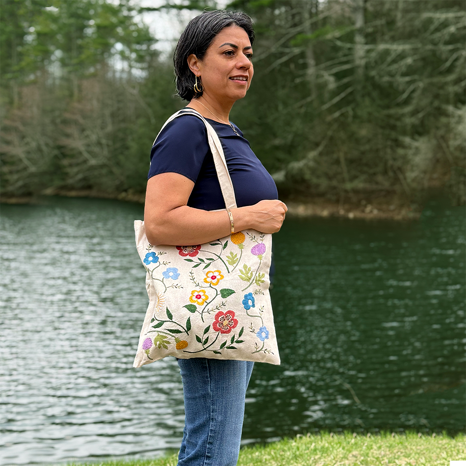 Cotton canvas tote bag with pink flowers embroidered on the front.