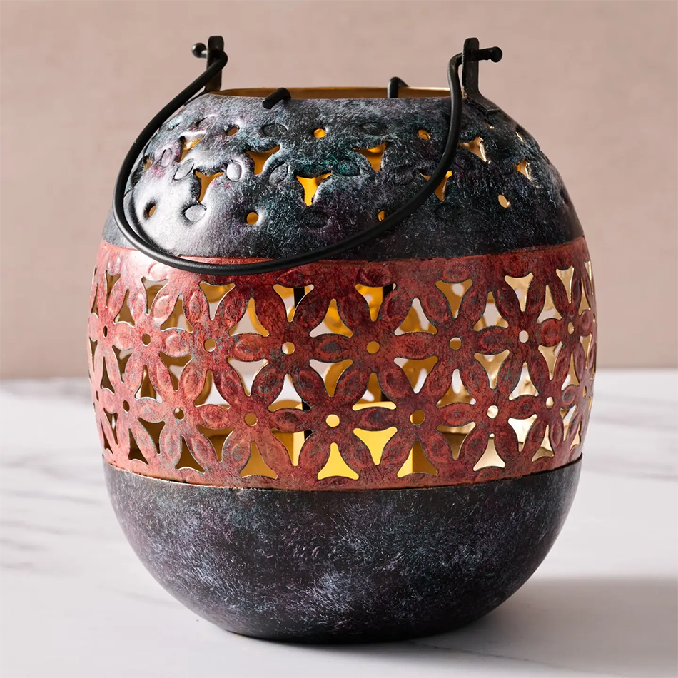 Painted iron lantern for tea lights with floral pattern.