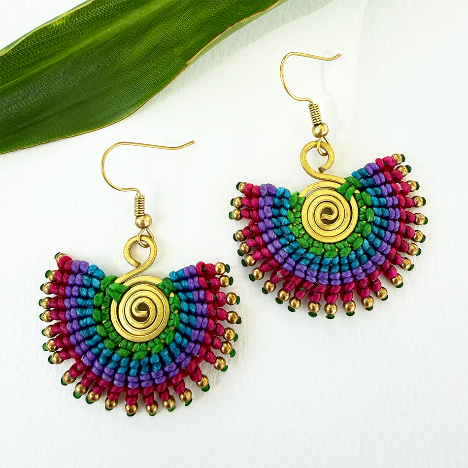 Colorful cotton and brass macrame earrings with brass spiral in center.