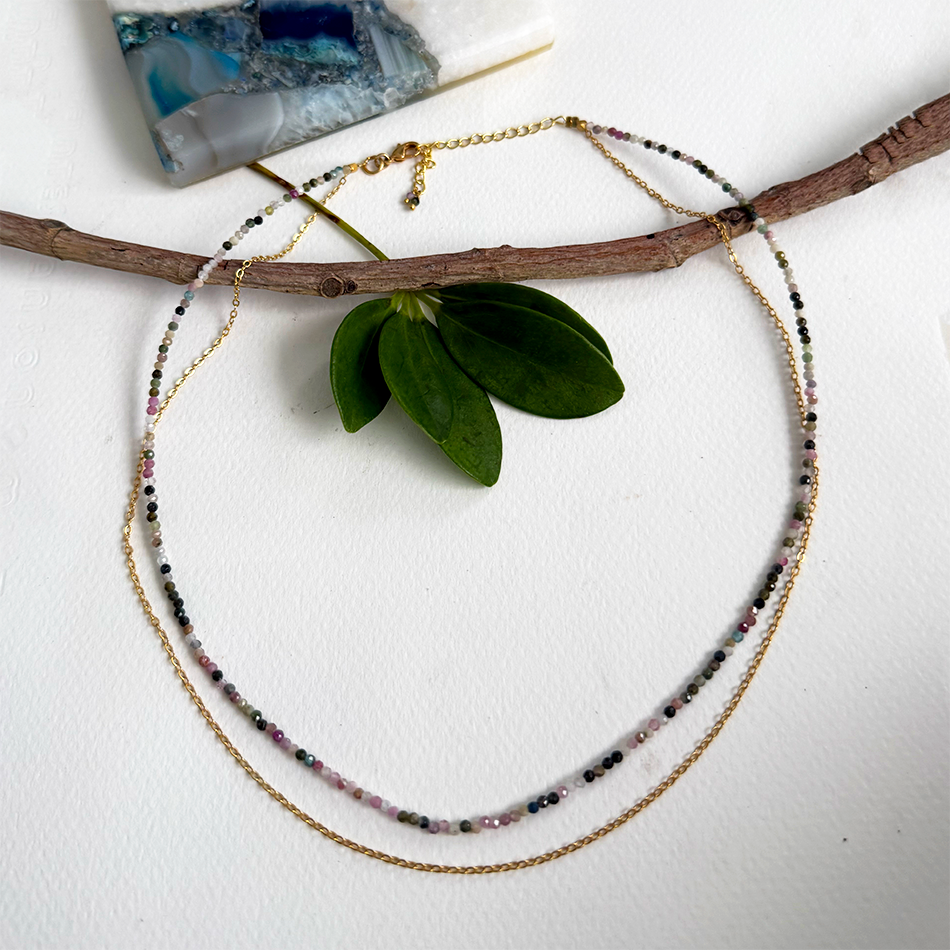 Necklace with 2 strands, one with tiny tourmaline stones the other a gold-plated chain.