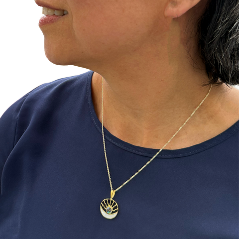 Brass round pendant with sun moon design and pearl and abalone