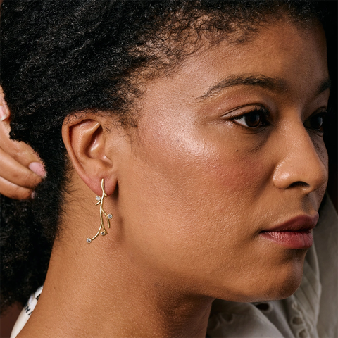 Gold post earrings with branches and zircon stones.