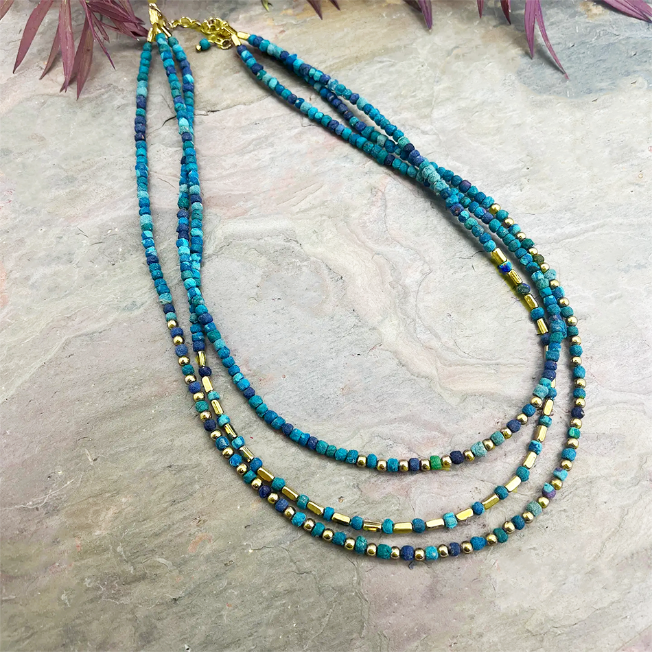 Three strand necklace blue sari fabric beads and gold beads.