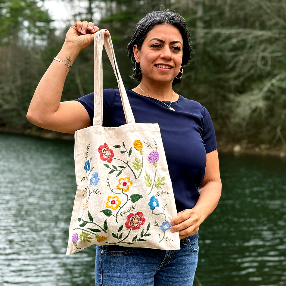 Cotton canvas tote bag with wildflowers embroidered on the front.