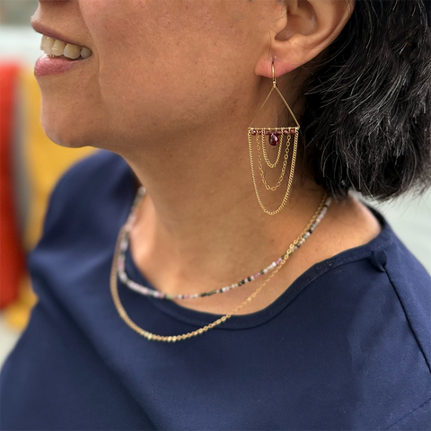 Brass earrings with multiple chains and garnet stone.