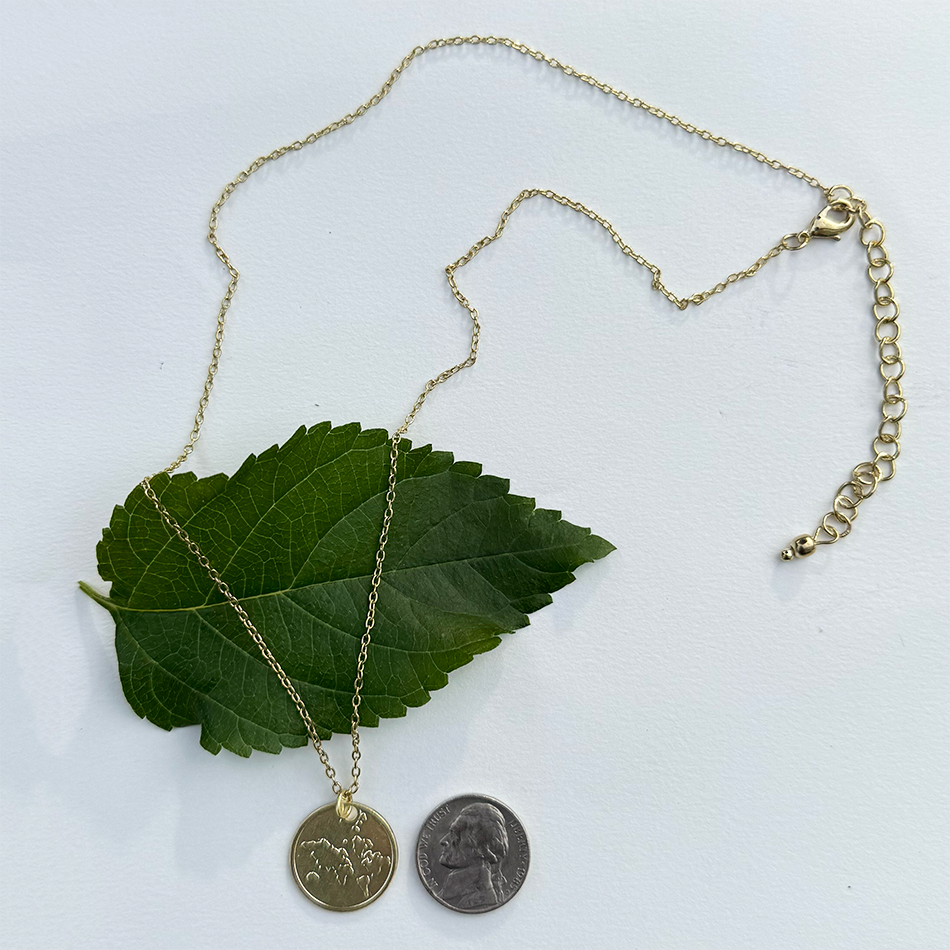 Fair trade gold-plated globe pendant.