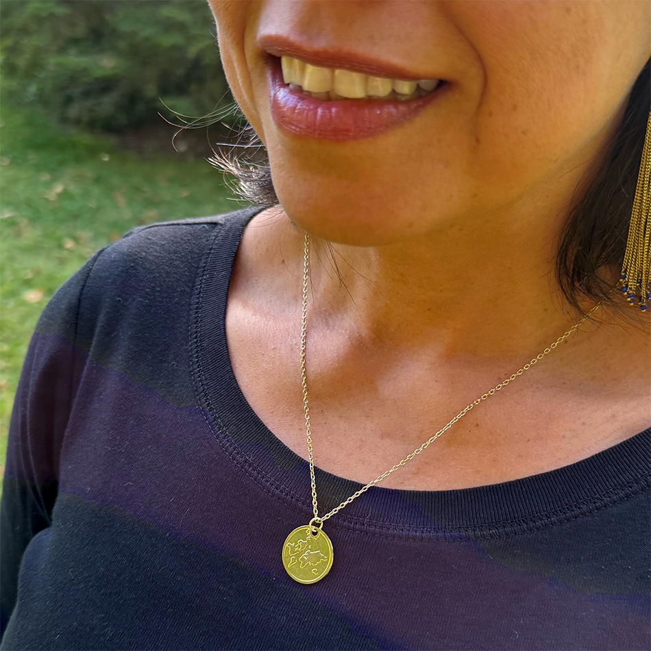 Fair trade gold-plated globe pendant.