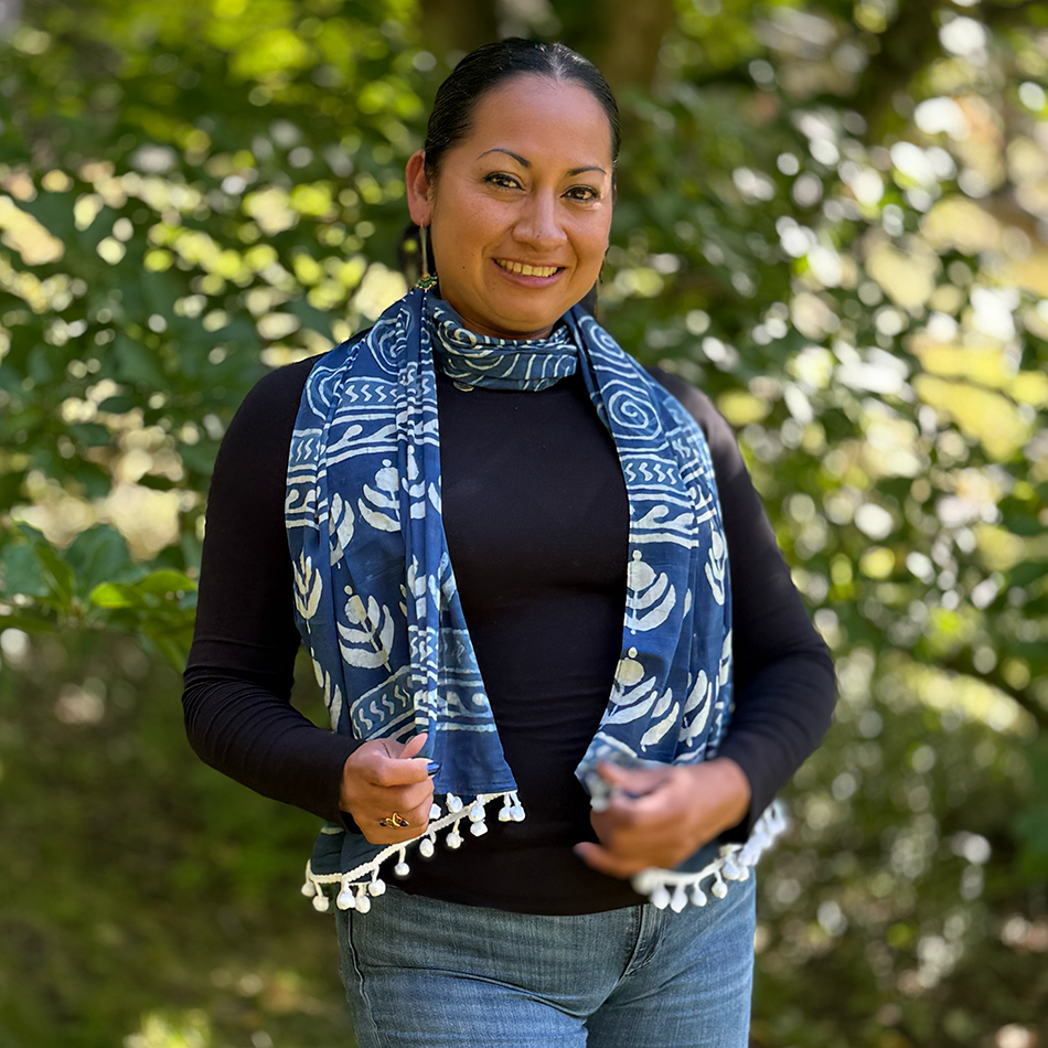 Fair trade indigo cotton scarf with spiral and flower design and pom poms.
