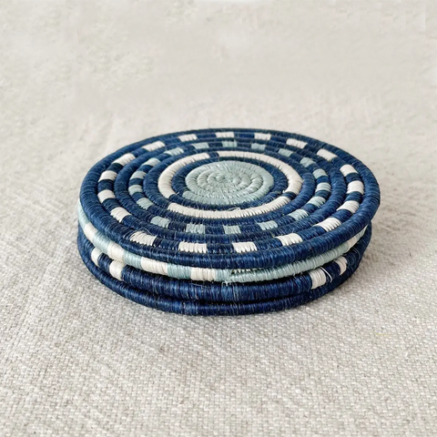 Fair trade handwoven coasters made in Rwanda out of sweetgrass.  Set of four in blue and white designs.