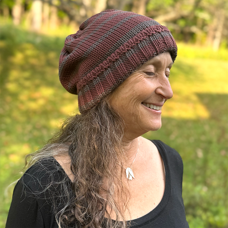 Fair trade organic cotton hat with burgundy and grey stripes.