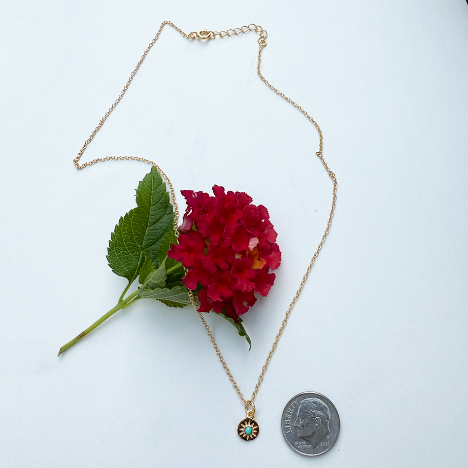 Fair trade tiny gold-plated compass necklace with turquoise stone.