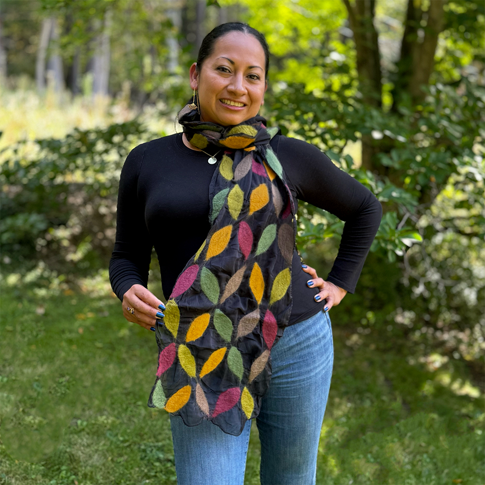Fair trade black silk scarf with felted colorful leaves on top.