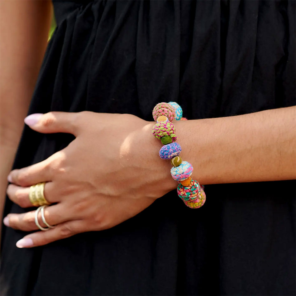 Fair trade statement bracelet handmade out of colorful recycled sari fabric beads.