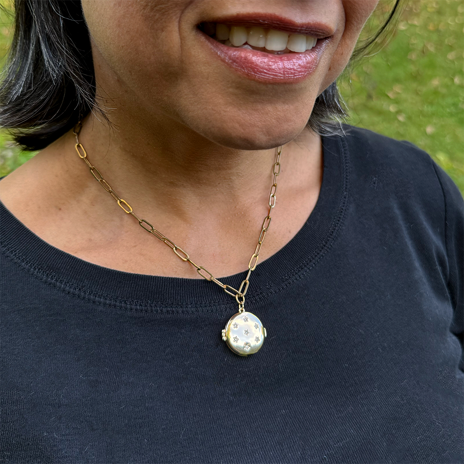 Fair trade gold-plated locket with crystal stars.