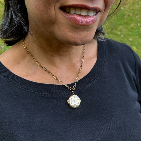 Fair trade gold-plated locket with crystal stars.