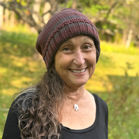 Fair trade organic cotton hat with burgundy and grey stripes.