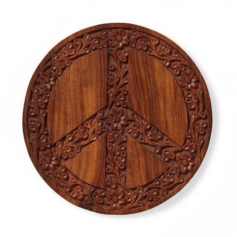 Fair trade wood trivet with peace sign and hand-carved flowers.