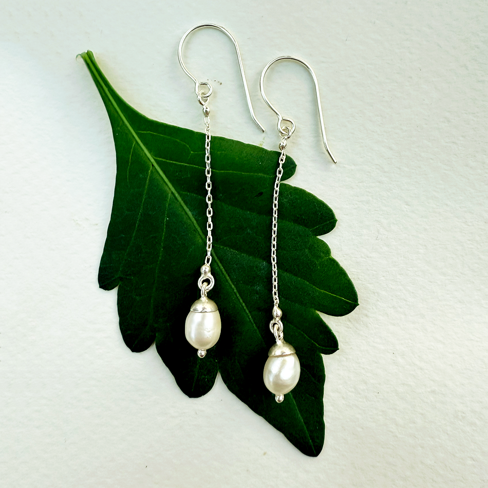 Sterling silver earrings with chain and pearl on the bottom.